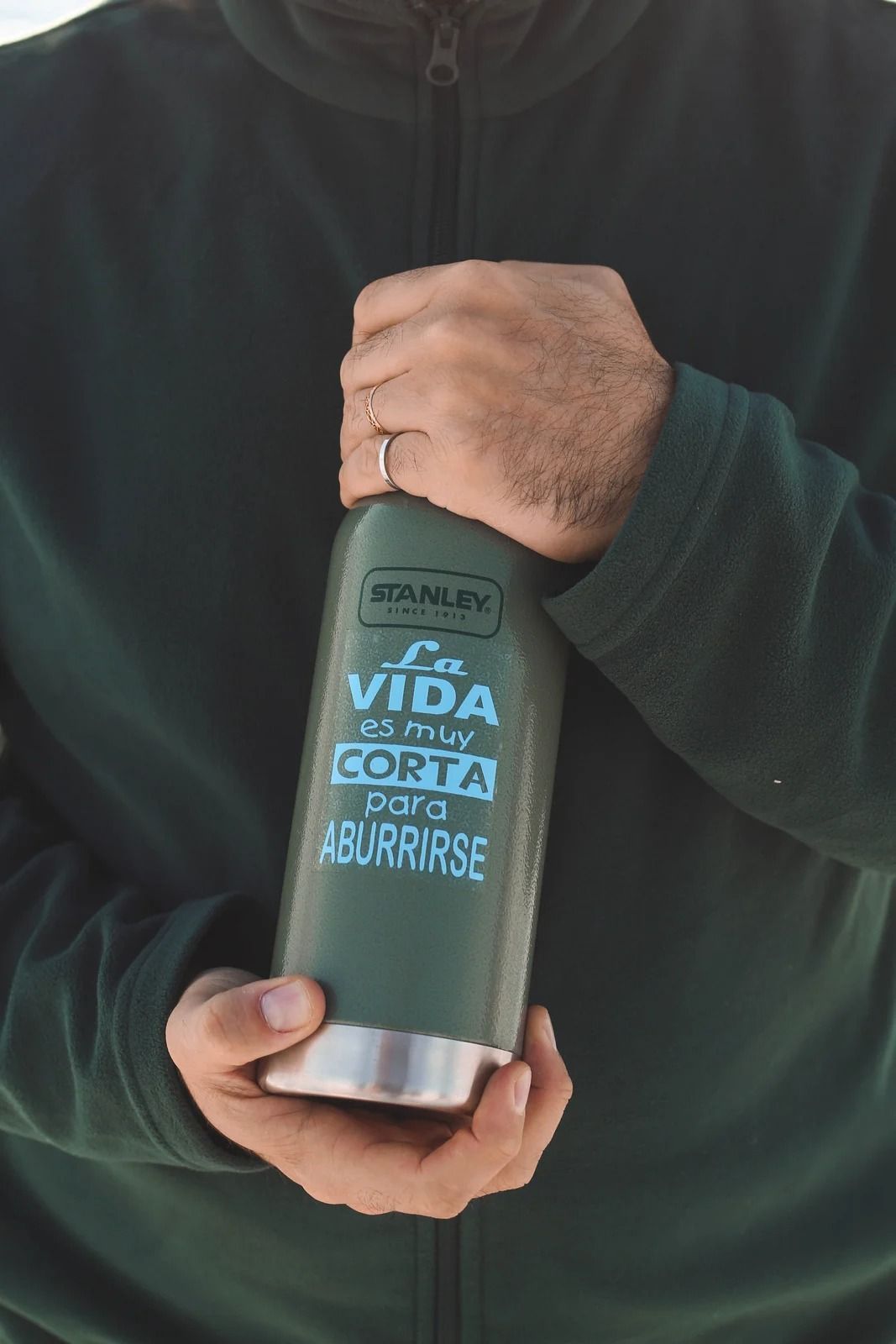 Person holding a green water bottle; text reads 