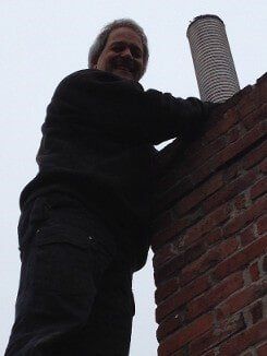 Employee Fixing Chimney - Chimney Cleaning in Norwood, MA