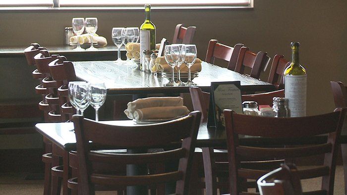 Wooden Table With Wine Glasses — Vincenzo's — Omaha, NE