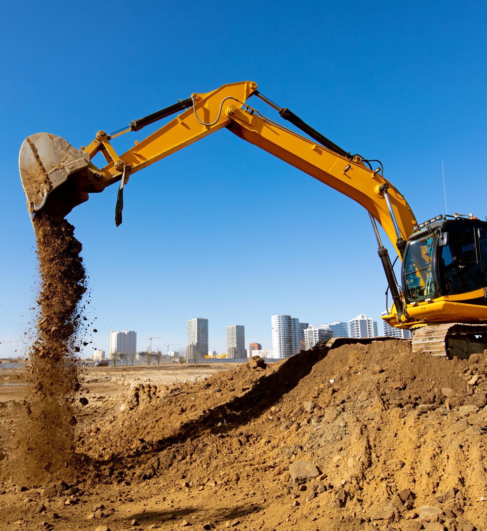 Excavator machine unloading sand or soil at construction site background.