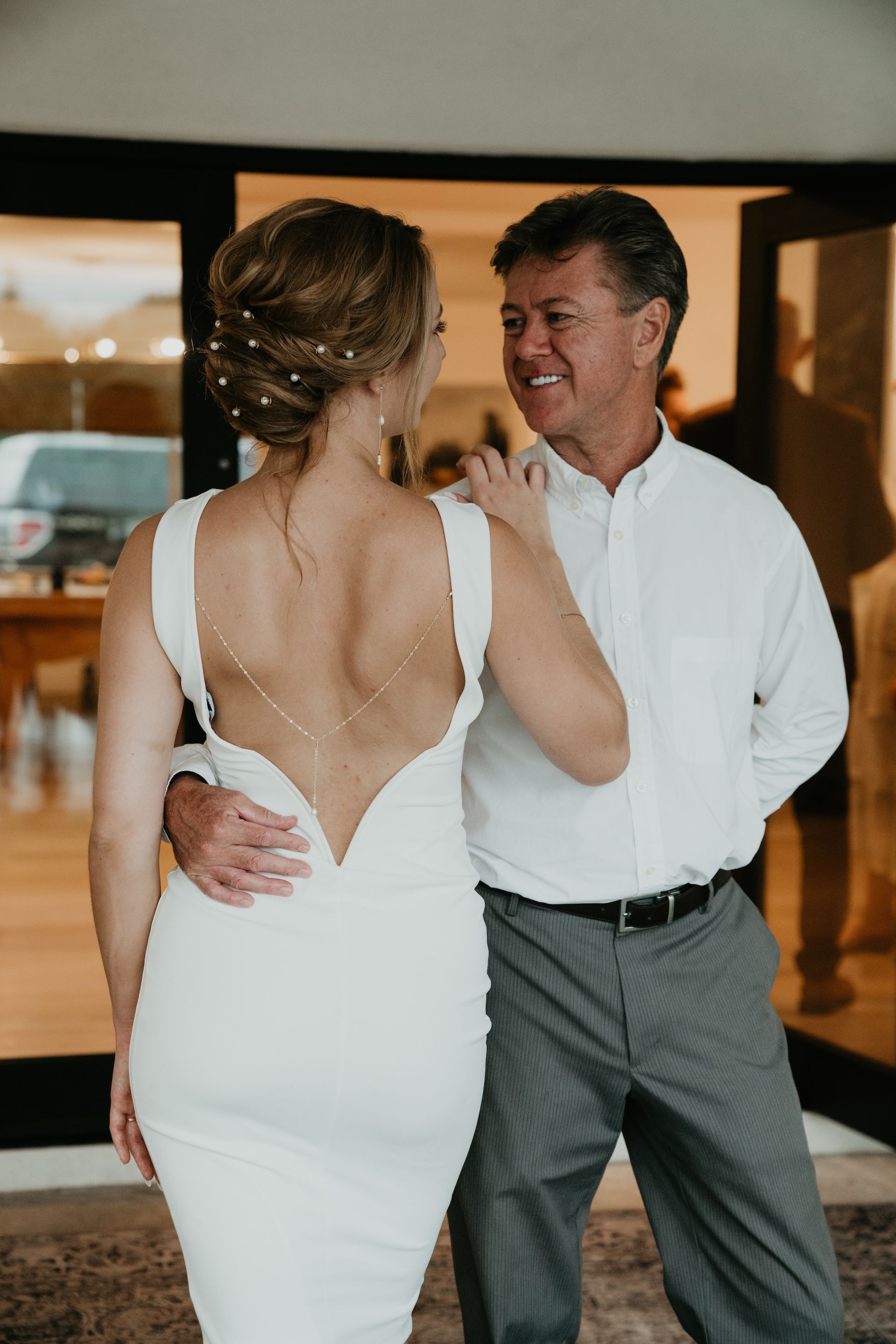 A bride and groom are dancing together at their wedding reception.