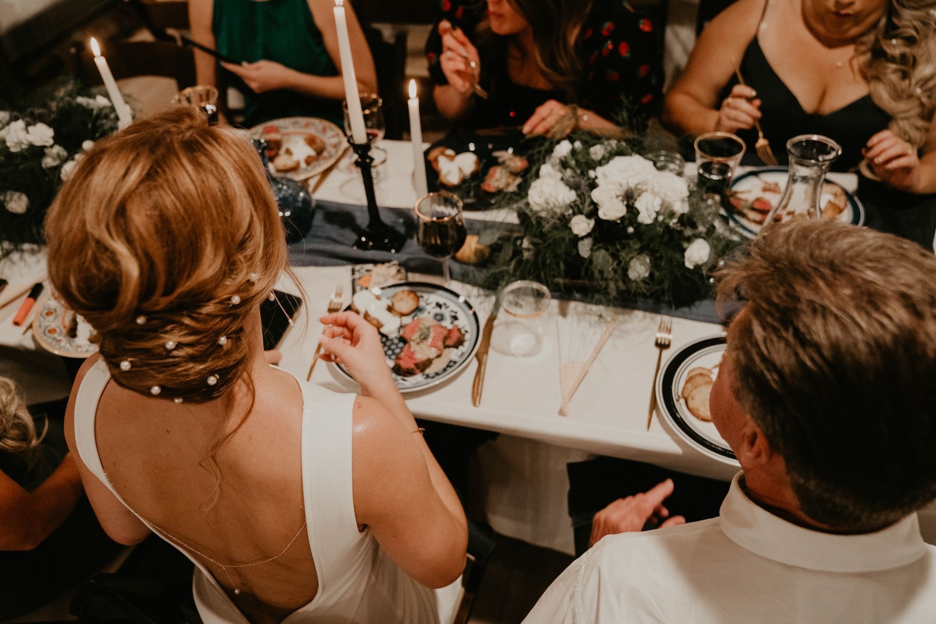 A group of people are sitting at a table eating food.