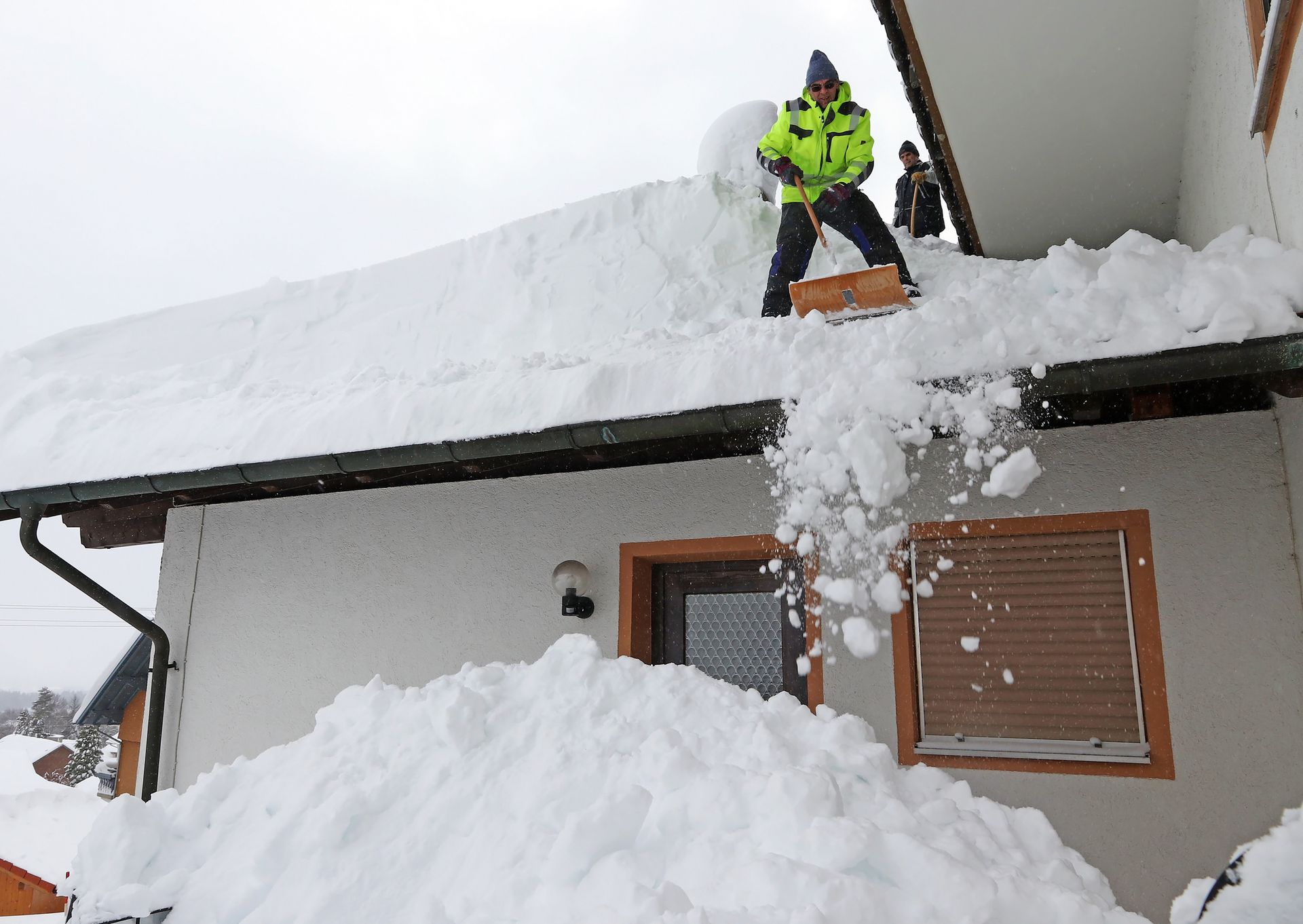 Clearing Snow in the Roof — Torrington, CT — EPB Roofing & Remodeling, LLC