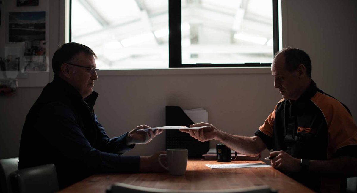 Paperwork exchanging hands