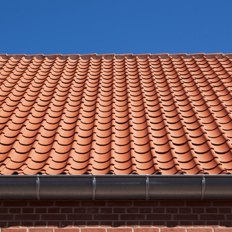 Ett rött tegeltak med en blå himmel i bakgrunden