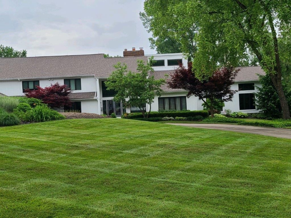 A large house with a lush green lawn in front of it
