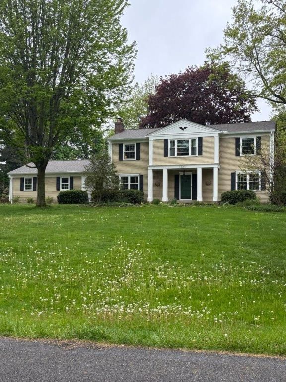 A large house with a large lawn in front of it