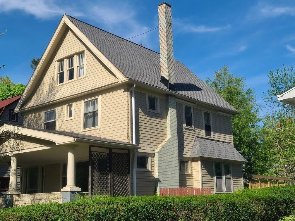 A large house with a chimney on top of it