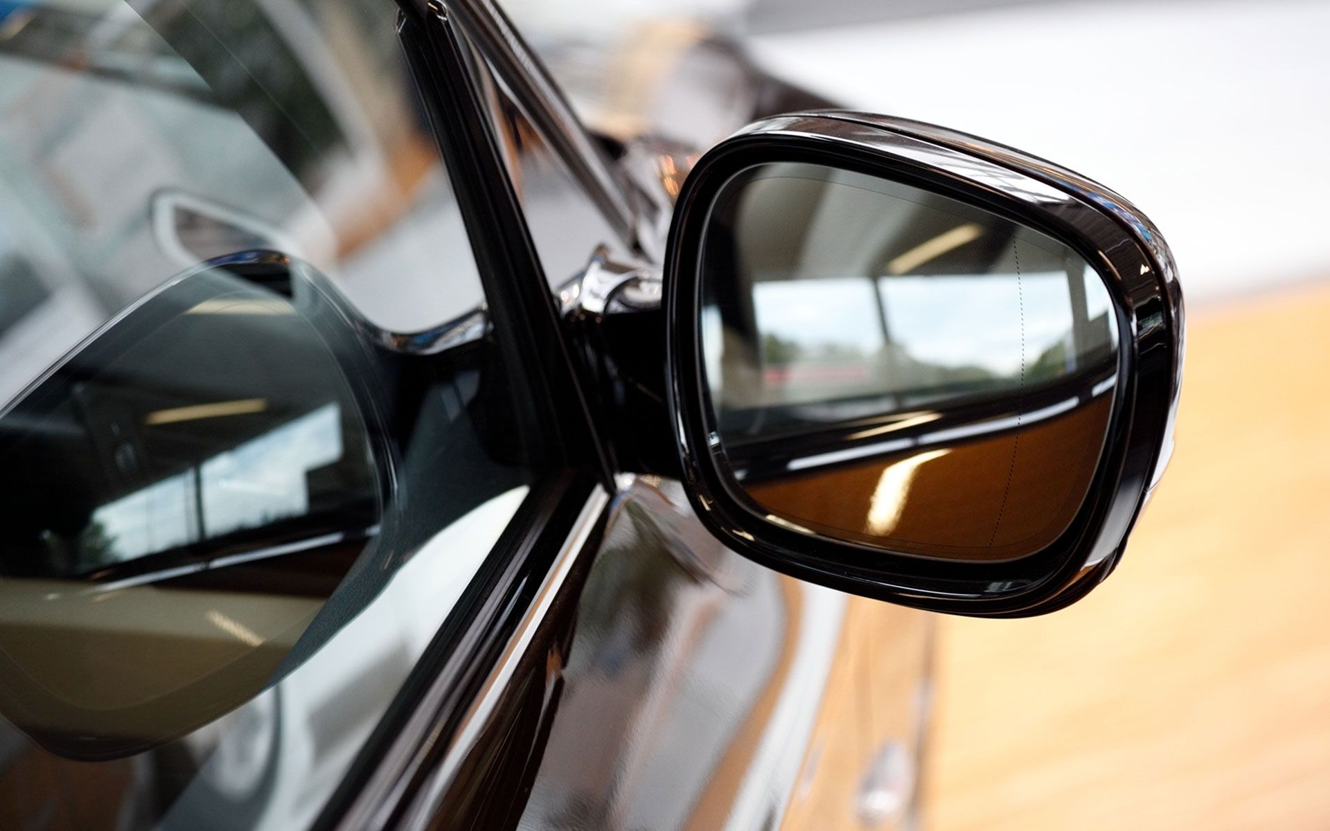 A close up of a side view mirror on a car.