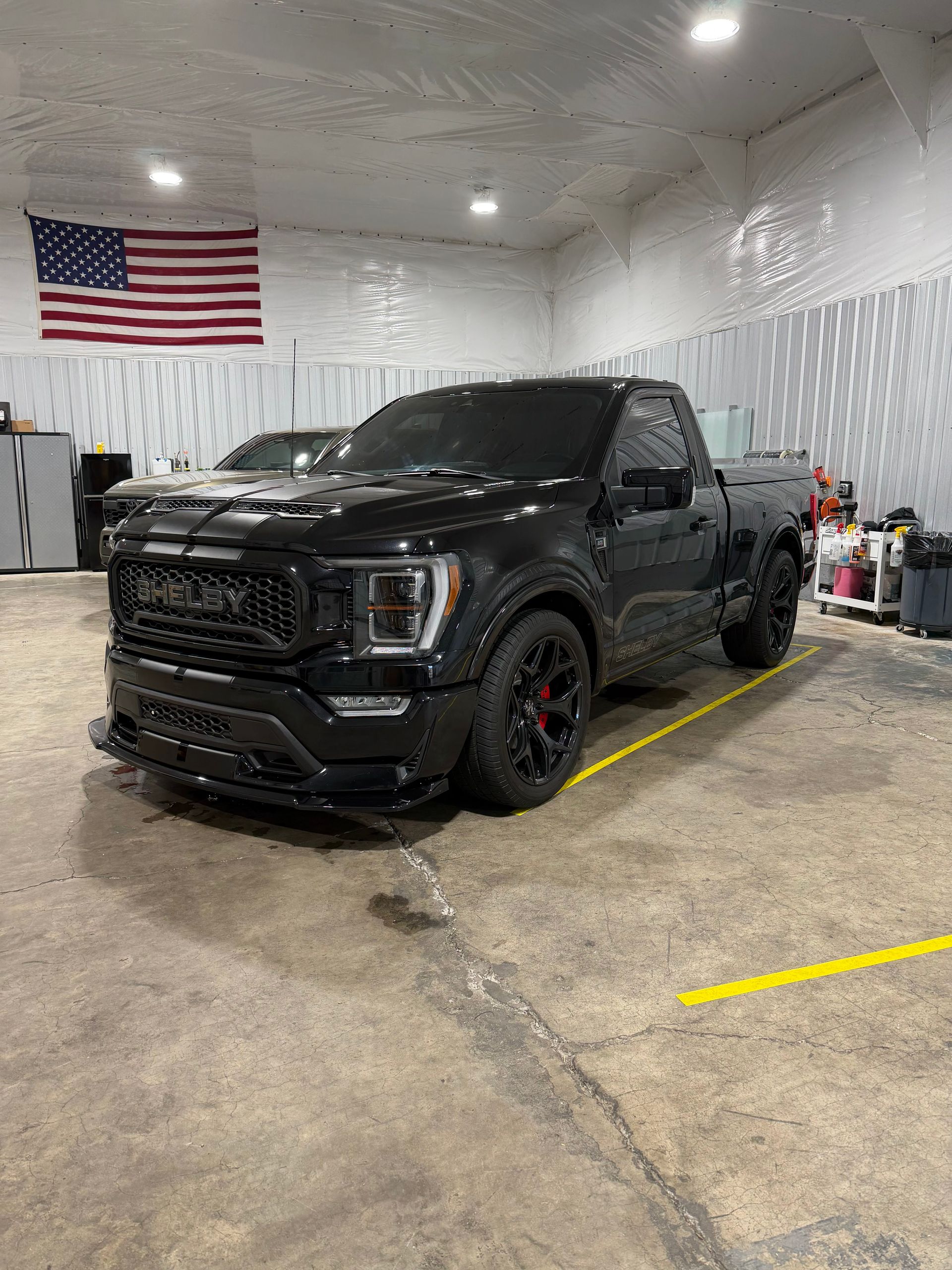 Black Shelby Super Snake Sport pickup truck with privacy-tinted windows inside a garage - Independence, OR