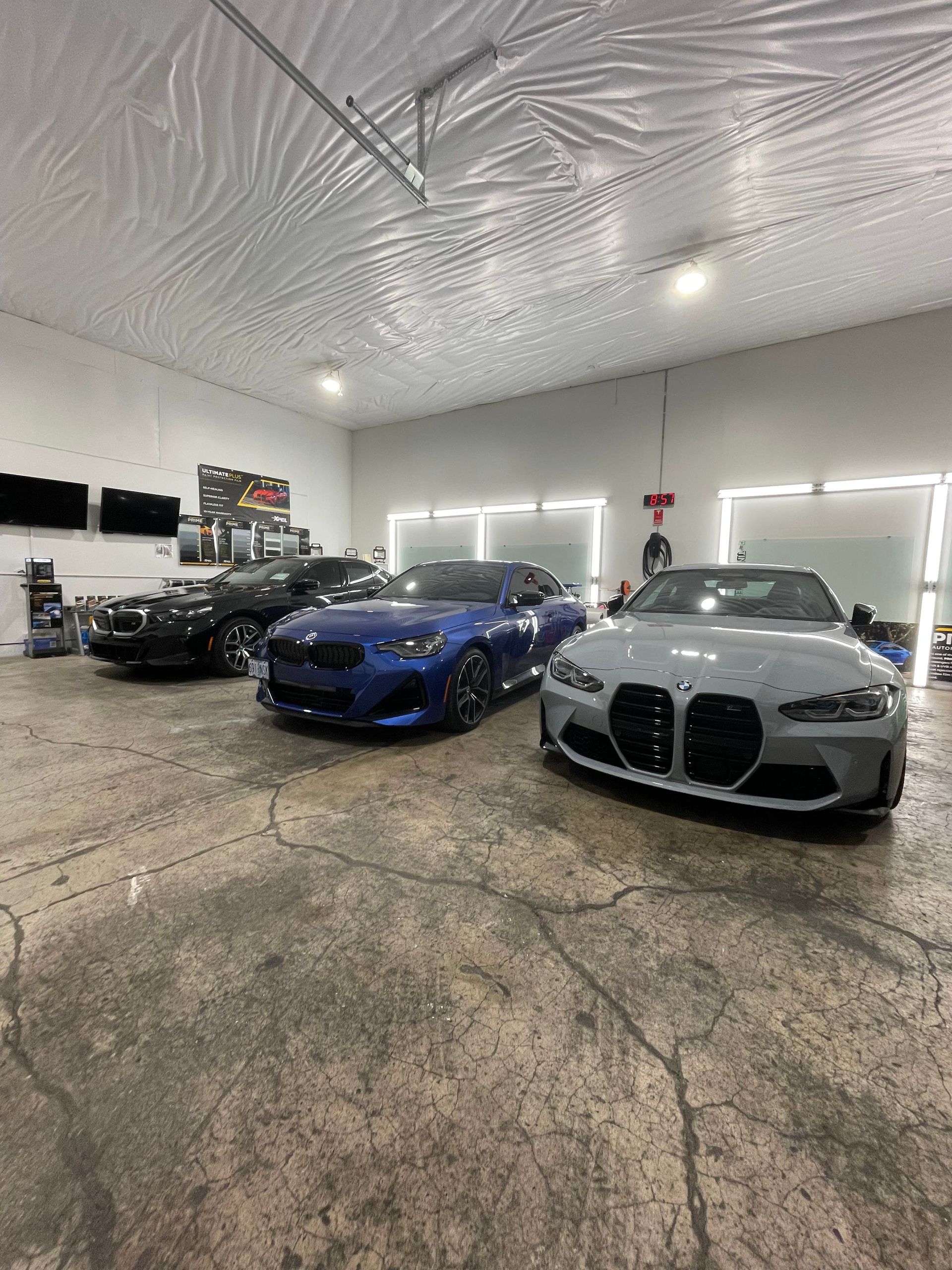 Three BMWs in a garage with newly installed PPF and window tint - West Salem, South Salem, and Wilsonville, OR