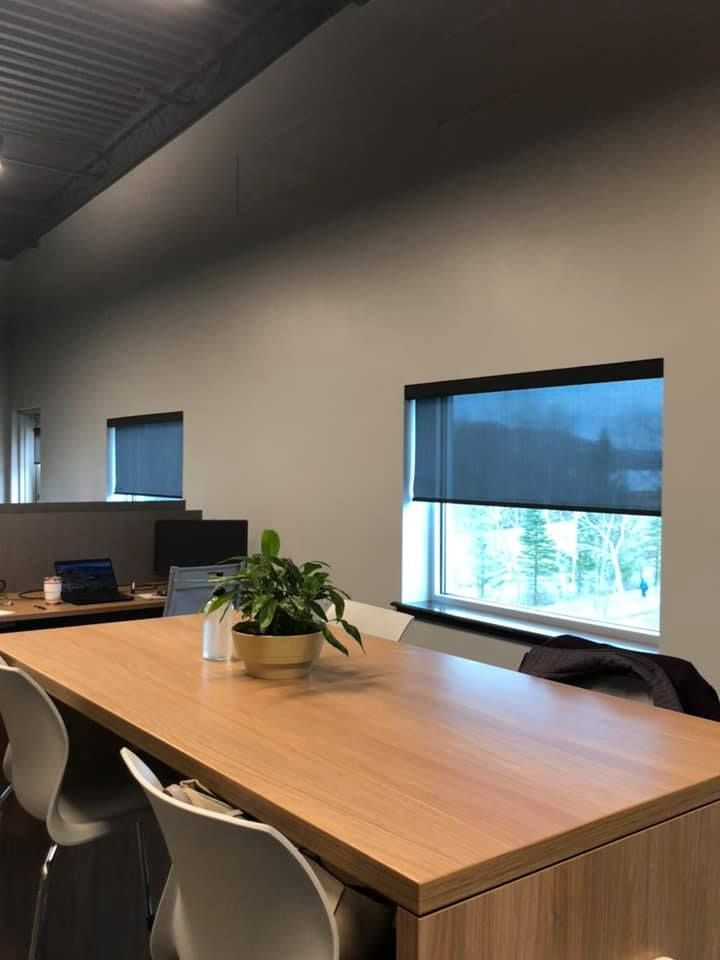 A conference room with a long wooden table and chairs.