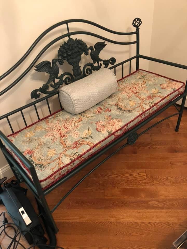 A couch is sitting in a living room next to a window.