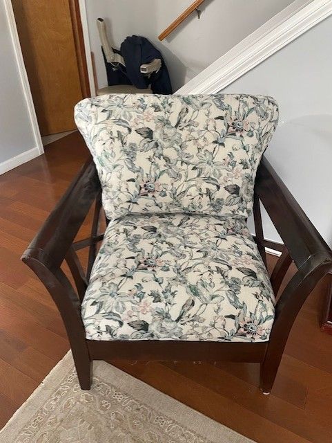 A chair is sitting on a wooden floor next to a table.