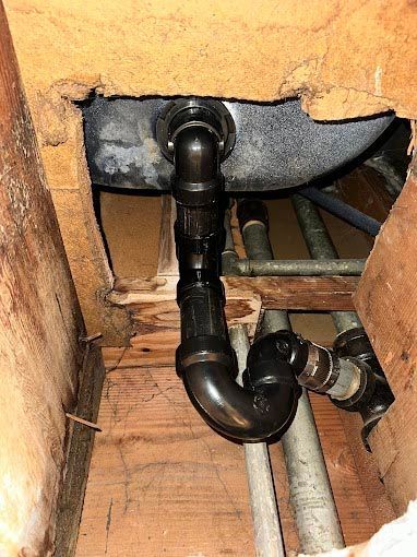 A bathroom sink is being installed in a hole in the wall.