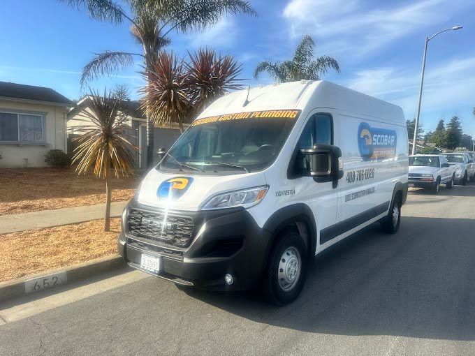 A white van is parked on the side of the road.