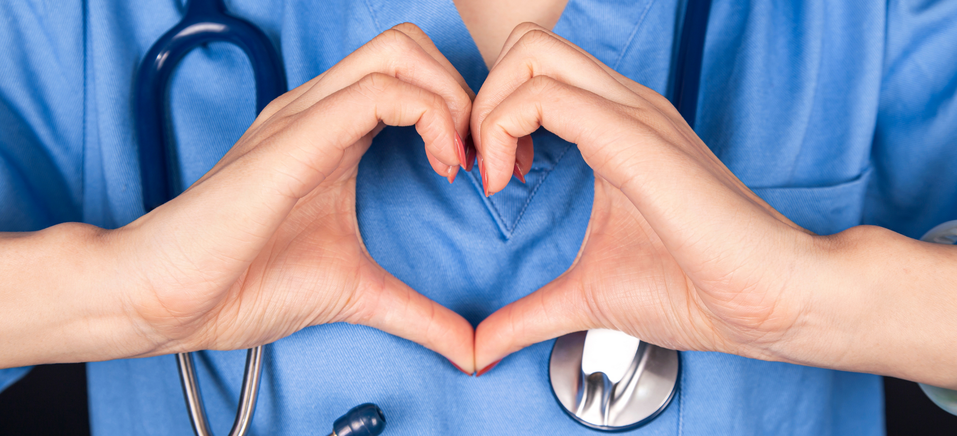 Doctor holding hands in a heart shape.