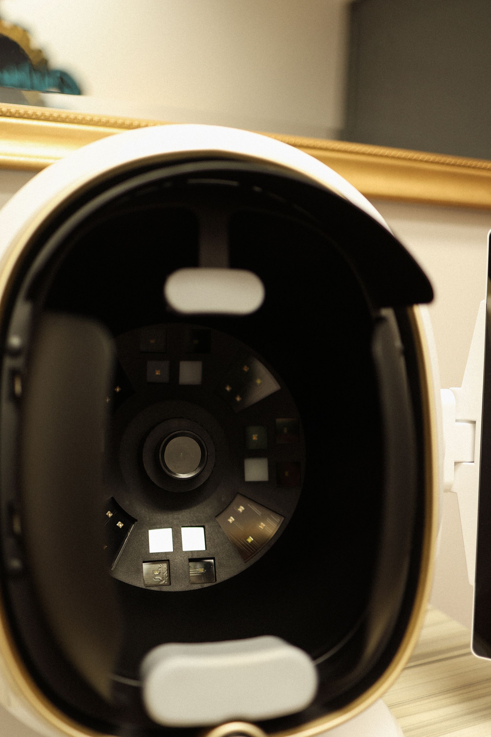 Close-up of a skin analysis device with a central lens and surrounding lights.