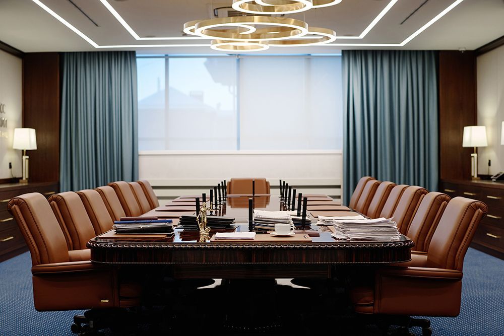 A conference room with a long table and chairs