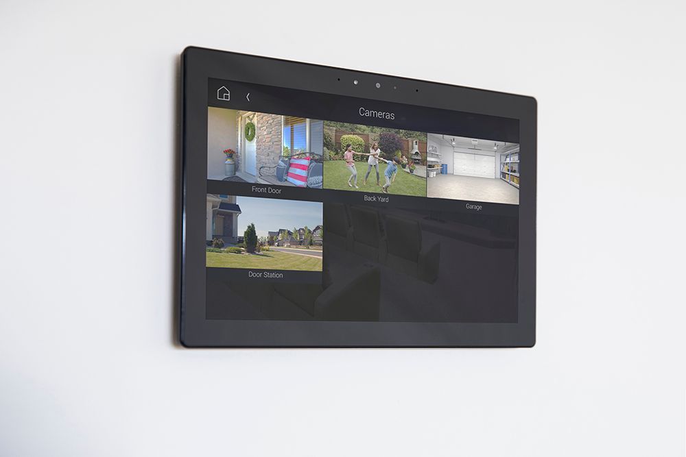 A tablet is hanging on a wall with a bunch of pictures on it.