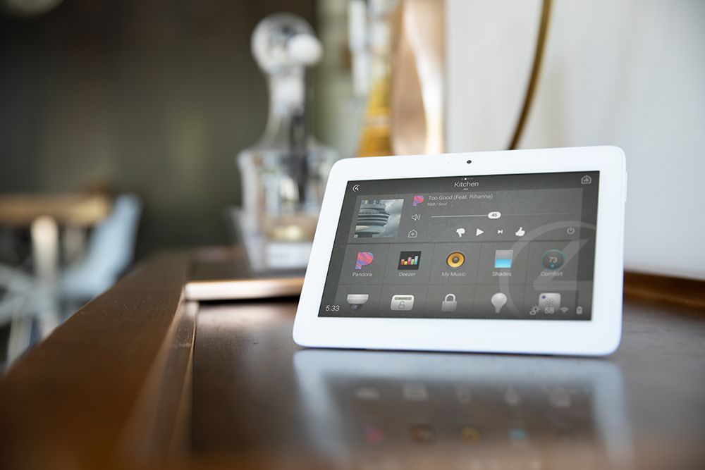 A white tablet sitting on top of a wooden table
