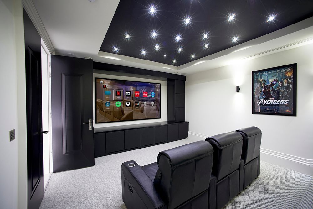 A home theater with a couch and a flat screen tv.