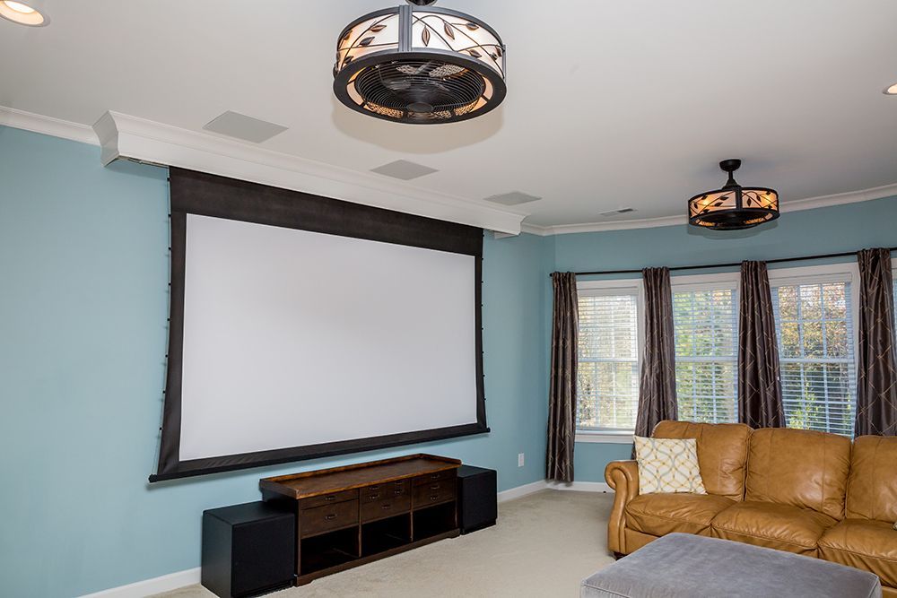 A living room with a projector screen and a couch