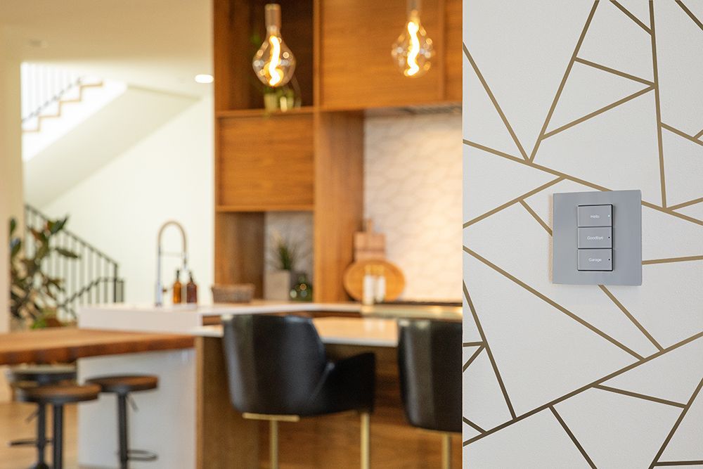 A kitchen with a bar and a light switch on the wall.