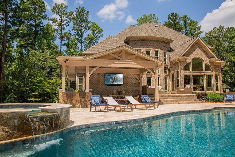 A large house with a swimming pool in front of it