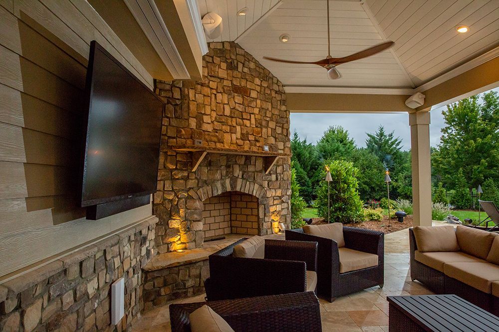 A living room with a fireplace and a flat screen tv.