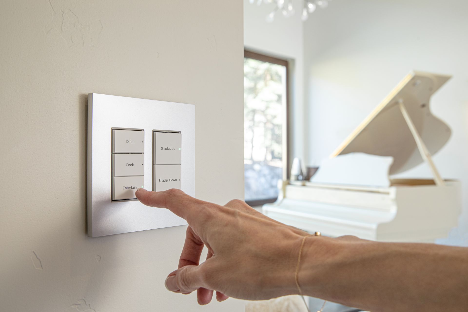 A person is pressing a button on a light switch in a living room.