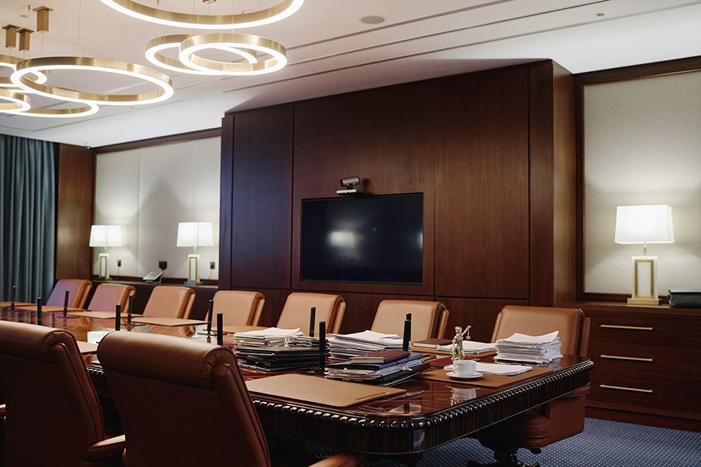 A conference room with a large table and chairs