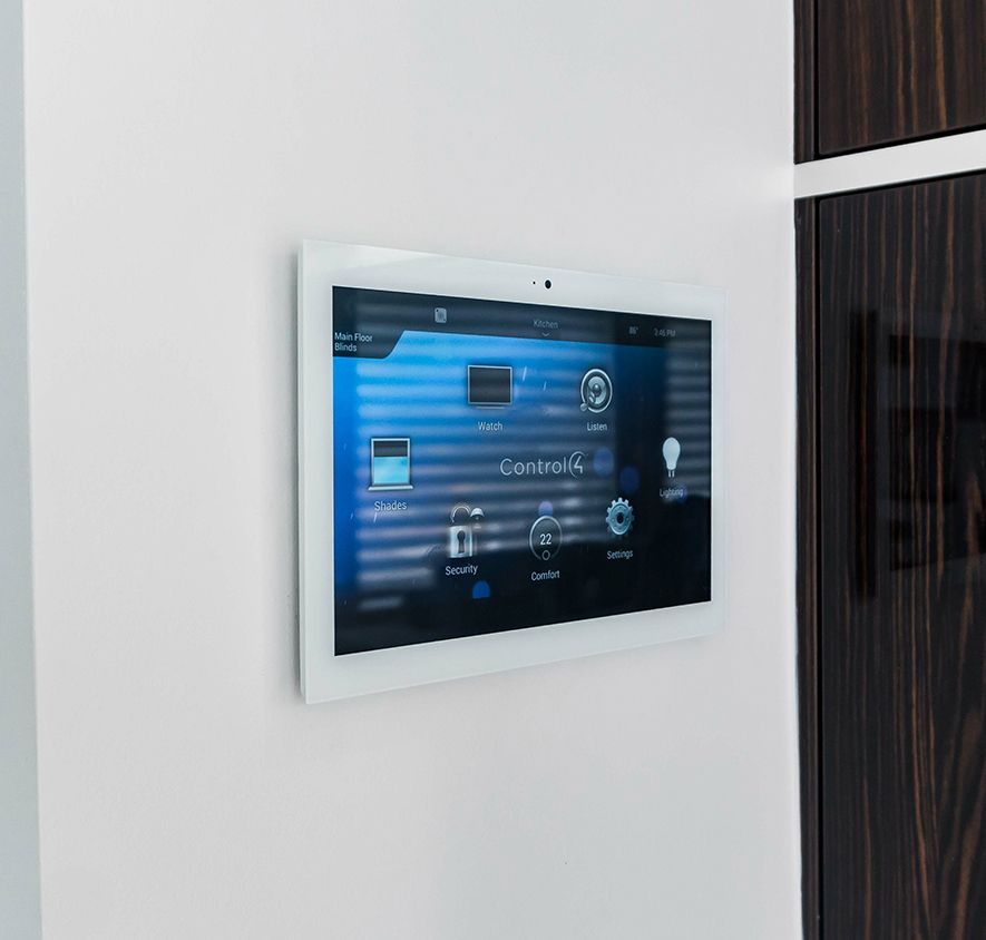 A white tablet is mounted on a white wall.