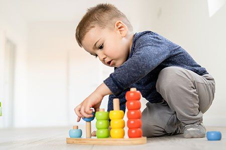 Boy Playing Colorful Toys — Philadelphia, PA — Learning World Child Academy