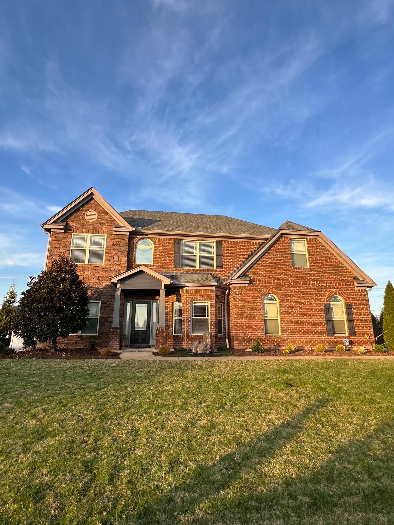 A man in a plaid shirt is using a laptop