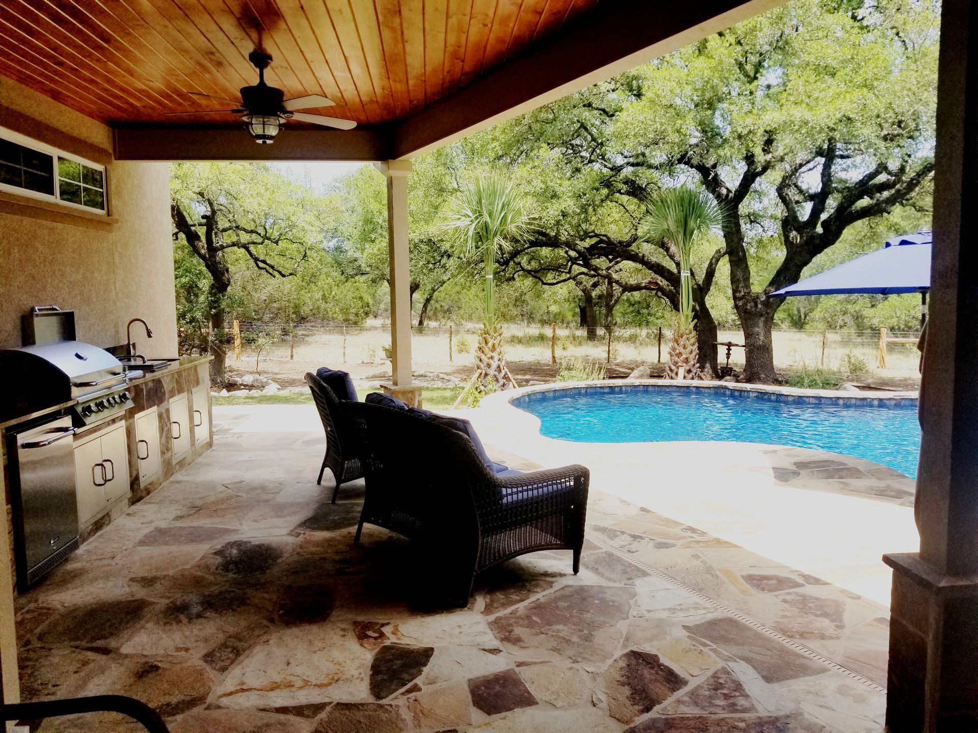 A large house with a swimming pool in front of it