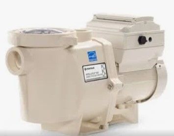 A white swimming pool pump is sitting on a white surface.