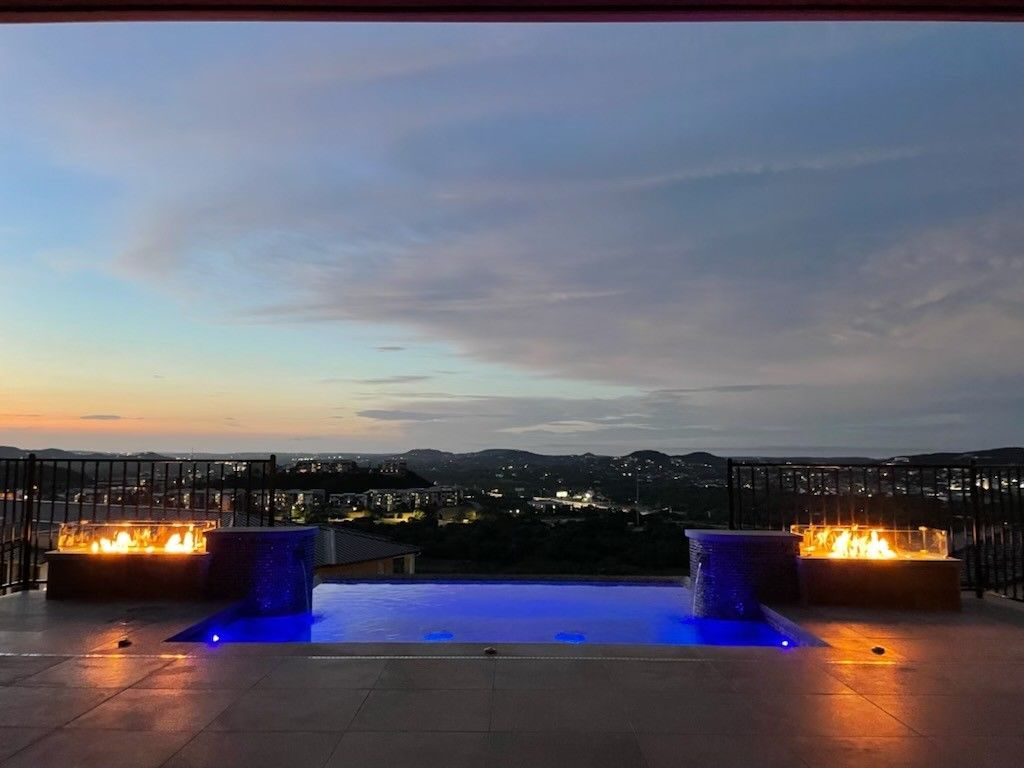 There is a waterfall in the middle of the pool.