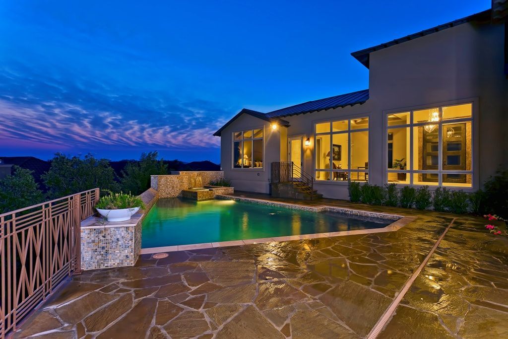 A large house with a swimming pool in front of it