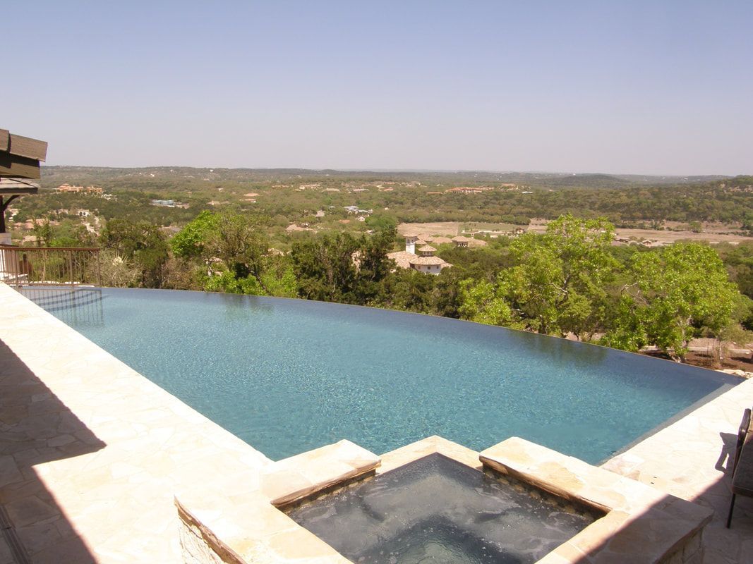 An infinity pool with a view of a valley and trees