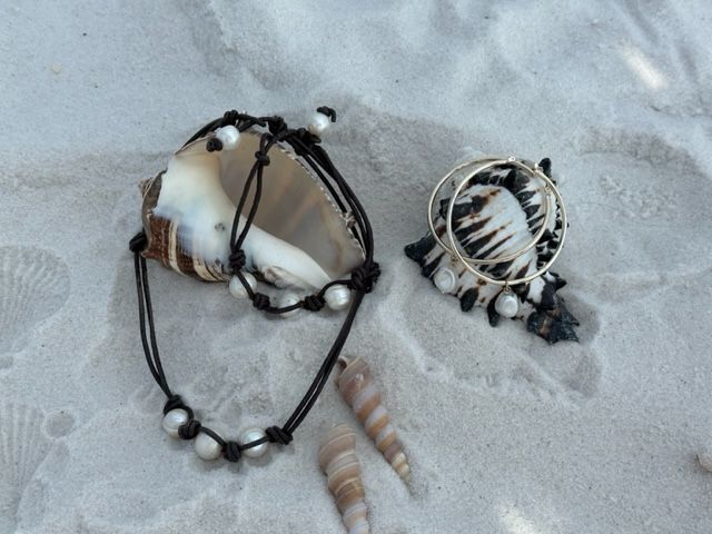 A bracelet and a ring are laying on the sand