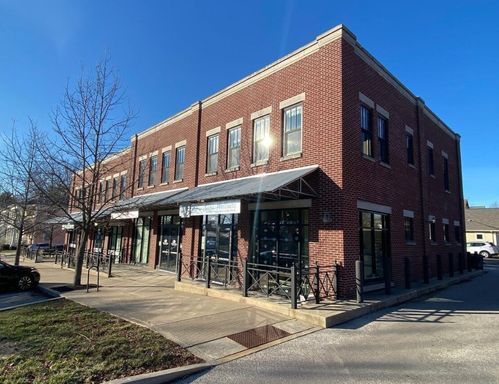 A large brick building with a lot of windows on a sunny day.