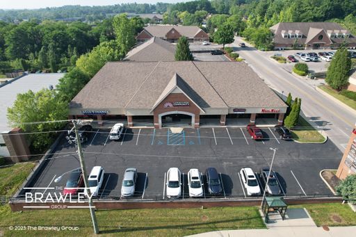 An aerial view of a building with cars parked in front of it