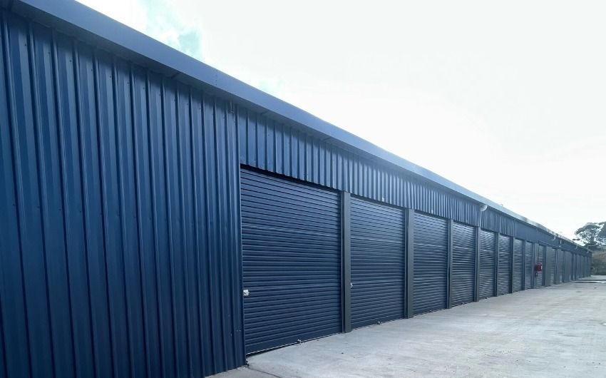 A row of storage units with boxes in them.