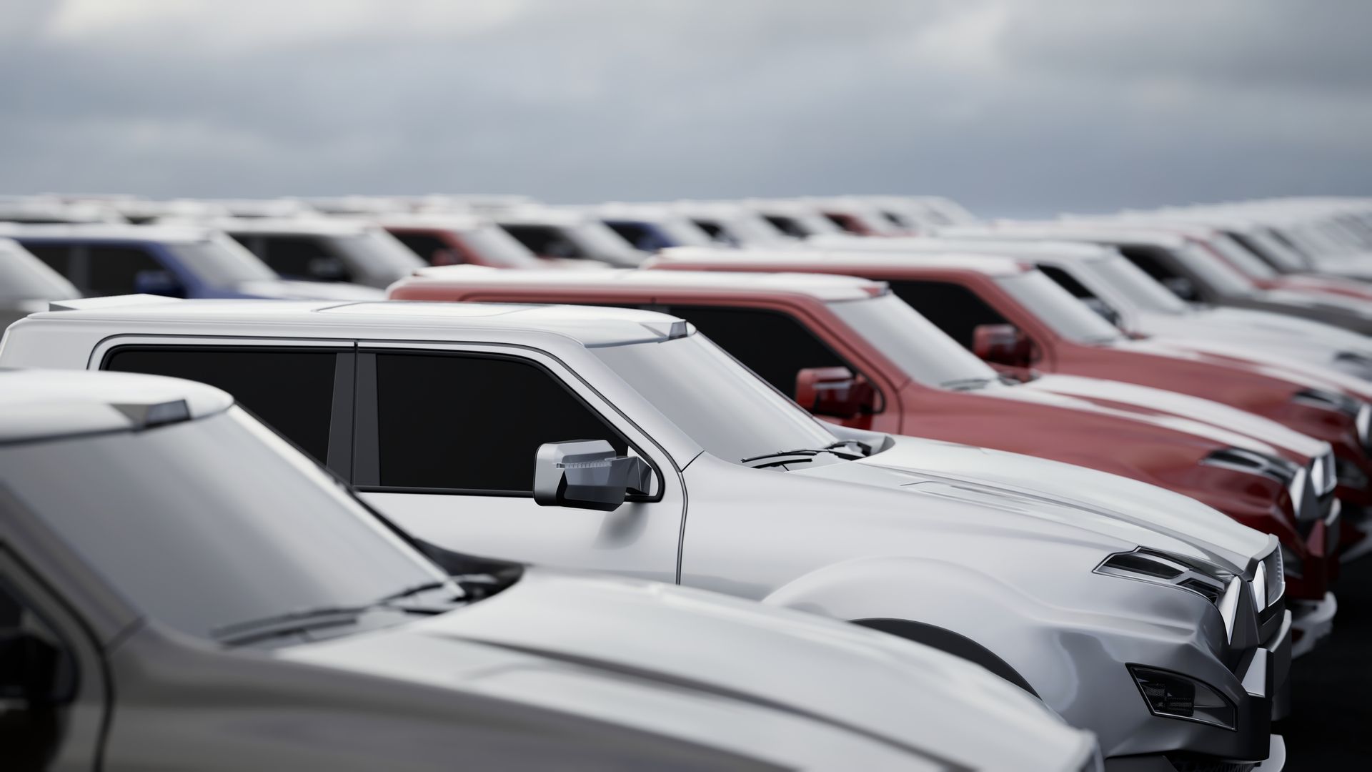 A row of cars are parked next to each other in a parking lot.