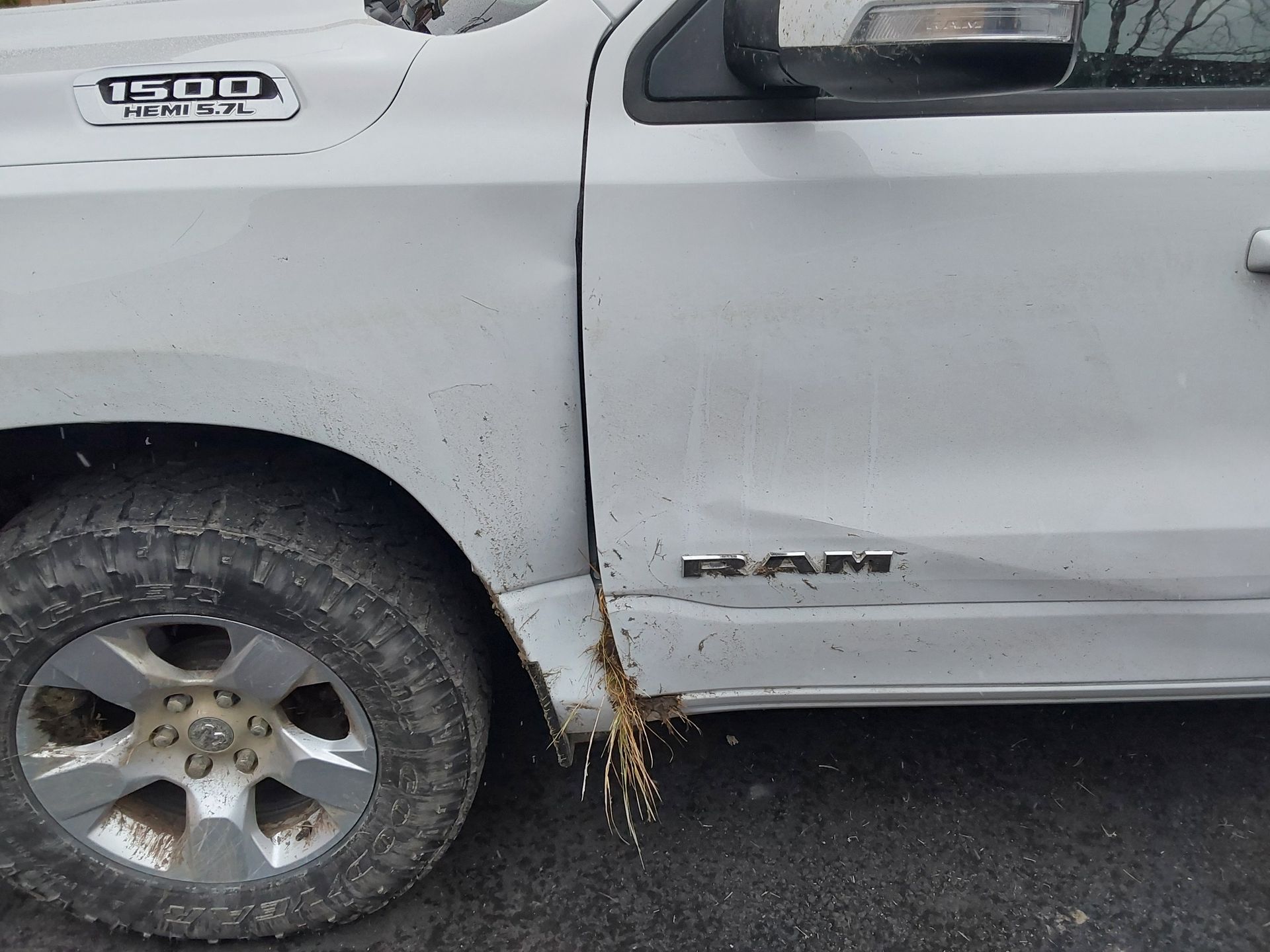A white ram truck is parked on the side of the road