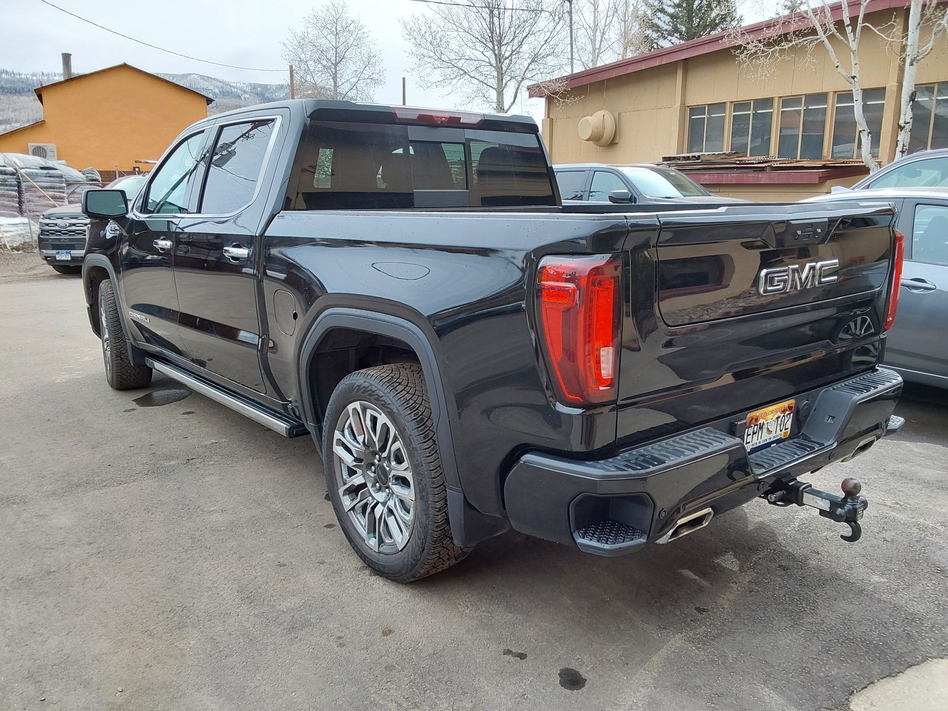 A black gmc truck is parked in a parking lot.