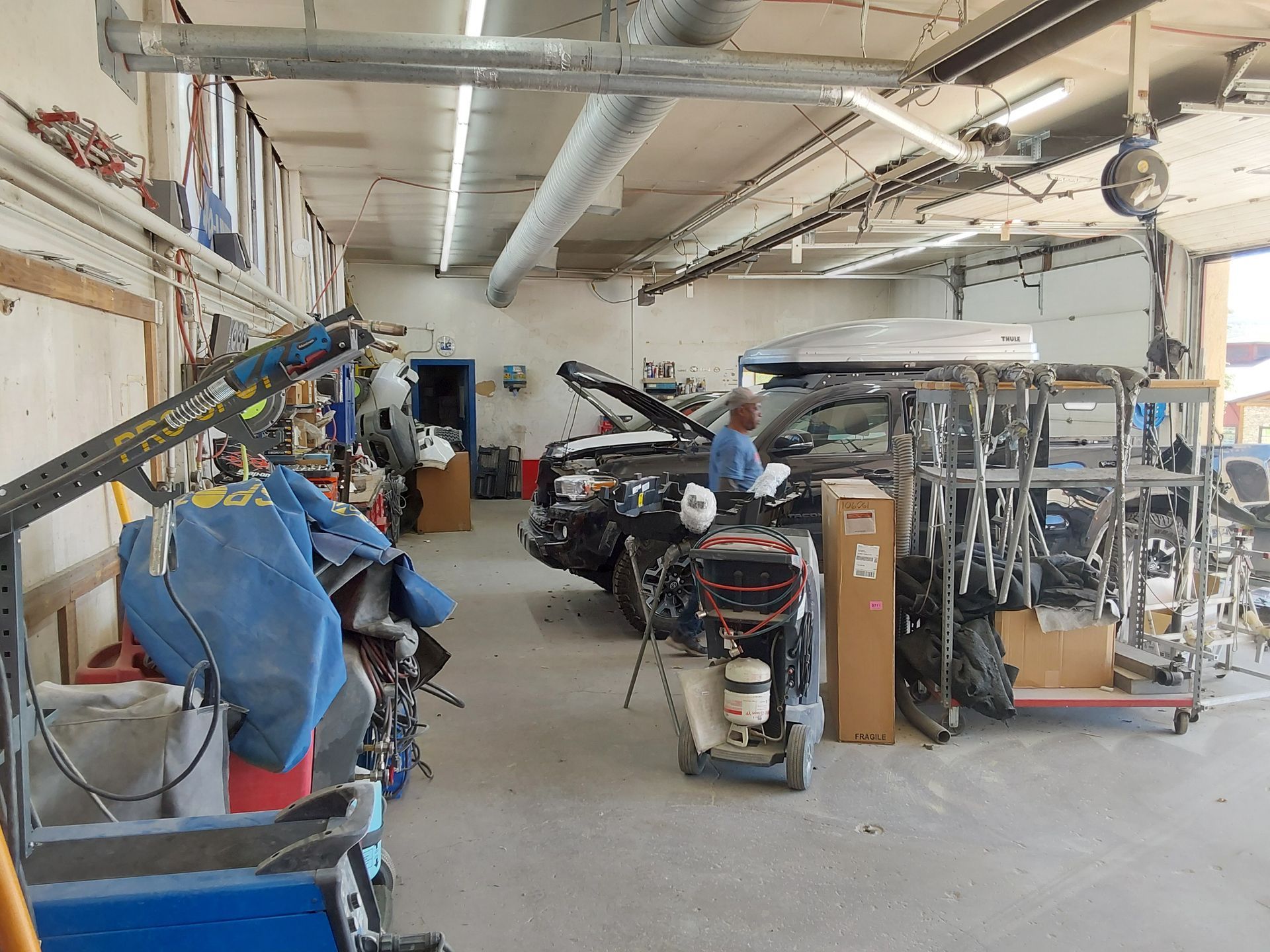 A man is working on a car in a garage.