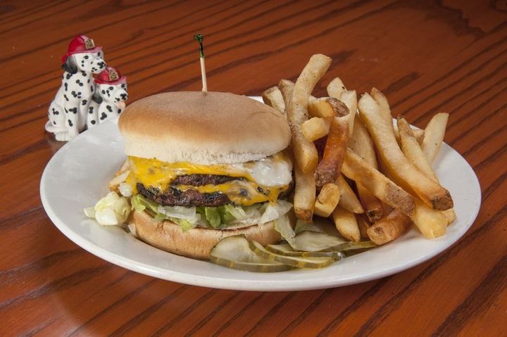 Double cheeseburger and fries on a plate.