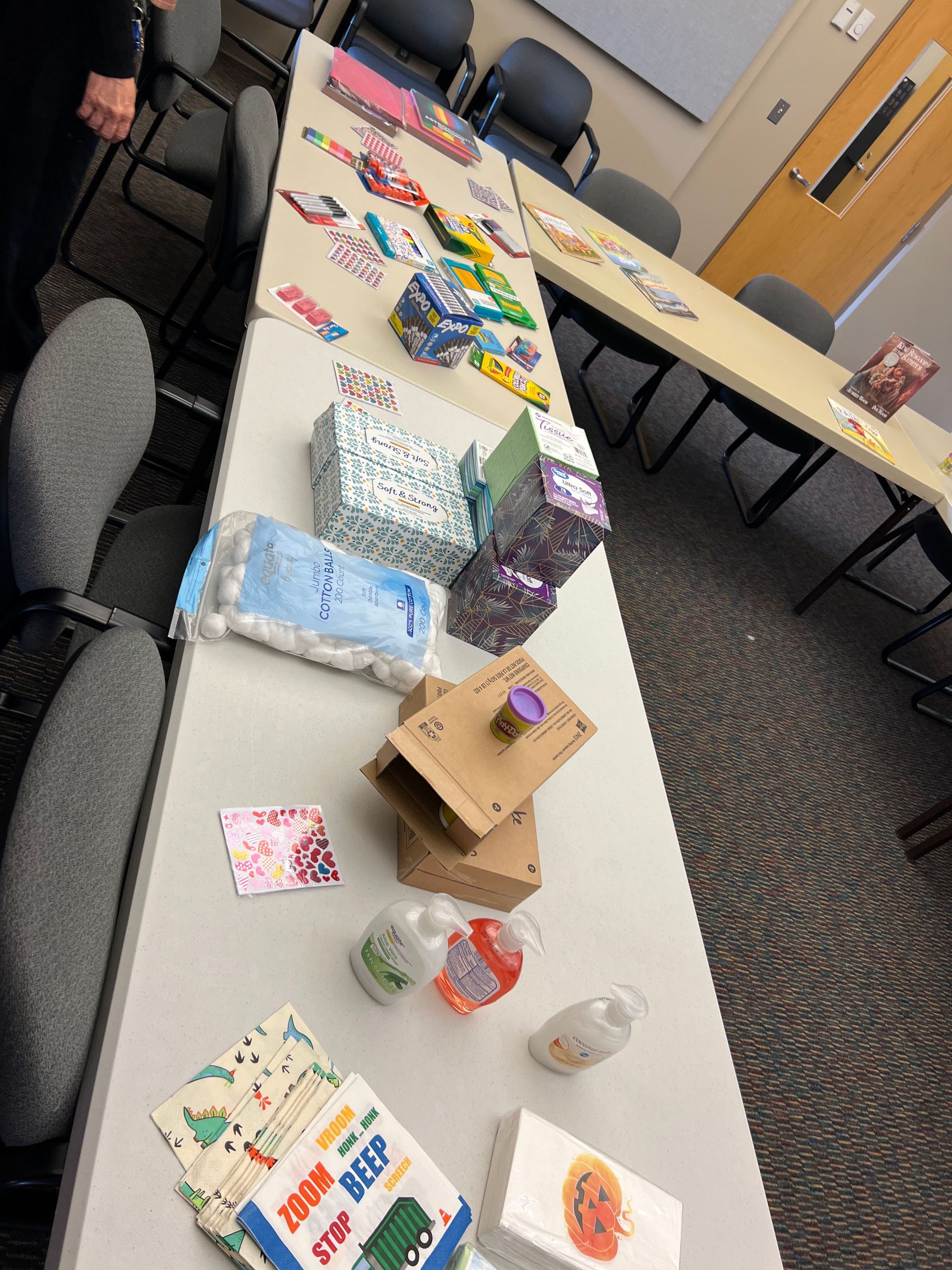 A bunch of different colored pencils are lined up in a row.